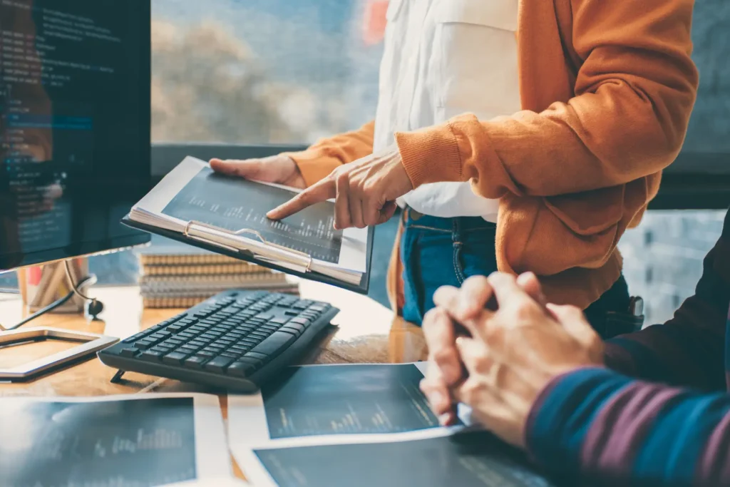 a manager points at printed inventory management data sets